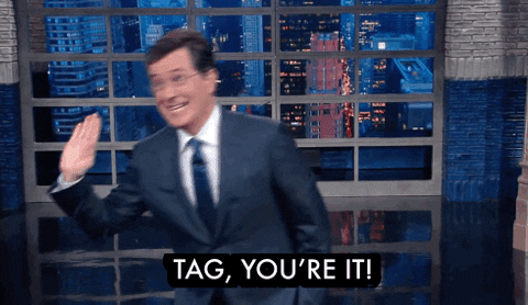 GIF image of Stephen Colbert, on the set of the Late Show, saying "Tag! You're it!" and running away.