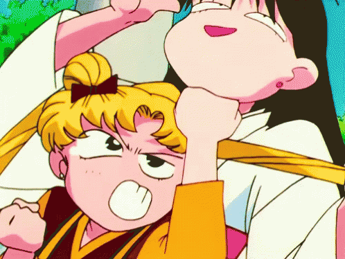 GIF of Sailor Moon aggressively rubbing Sailor Mars’ chin with her fist.  They both have very goofy, classic anime expressions.